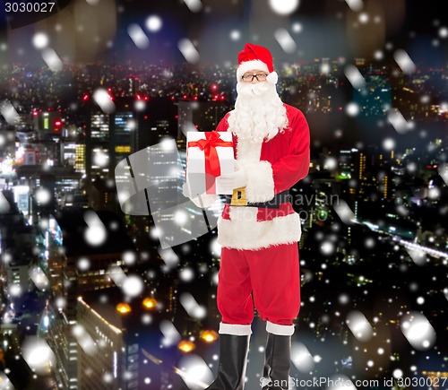 Image of man in costume of santa claus with gift box