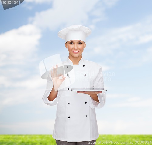 Image of smiling female chef with tablet pc computer