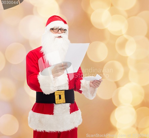 Image of man in costume of santa claus with letter