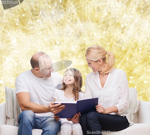 Image of happy family with book at home