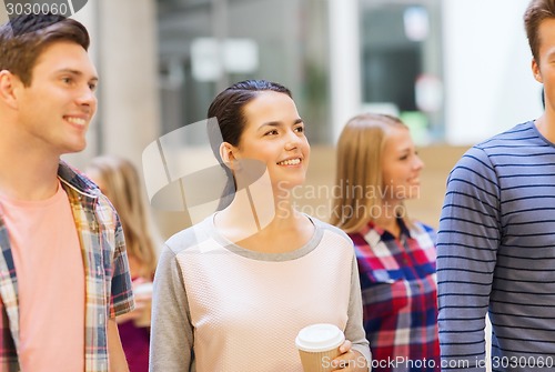 Image of group of smiling students with paper coffee cups