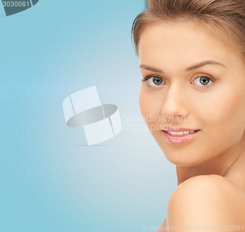 Image of beautiful young woman over blue background