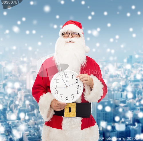 Image of man in costume of santa claus with clock