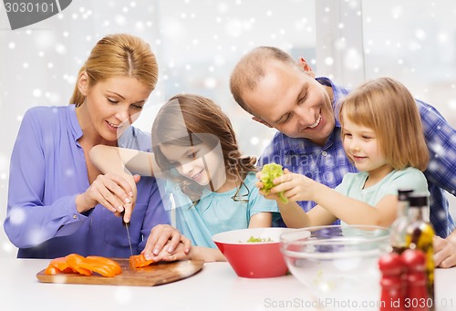 Image of happy family with two kids making dinner at home