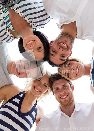 Image of smiling friends in circle