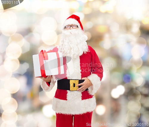 Image of man in costume of santa claus with gift box