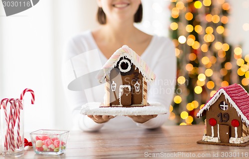 Image of close up of woman showing gingerbread house