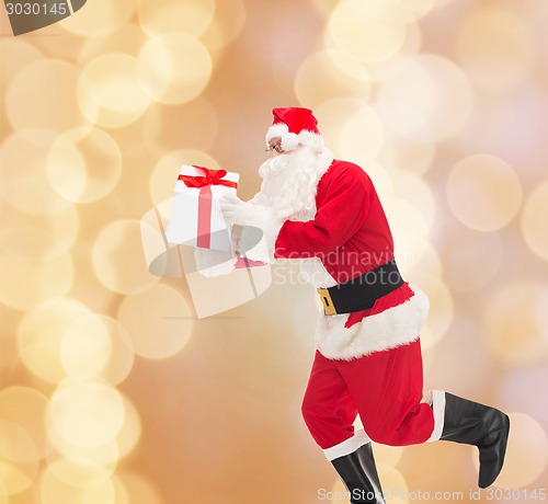 Image of man in costume of santa claus with gift box