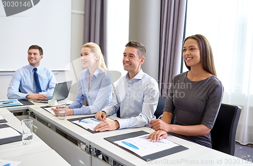 Image of smiling business people meeting in office