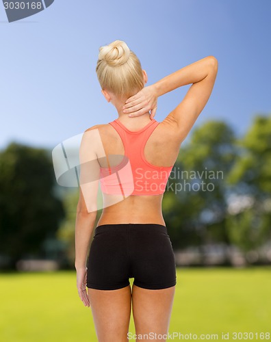 Image of sporty woman touching her neck