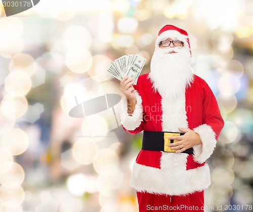 Image of man in costume of santa claus with dollar money