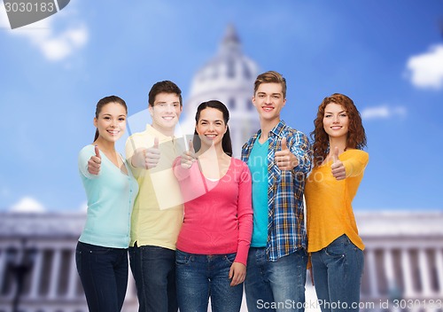 Image of group of smiling teenagers showing ok sign