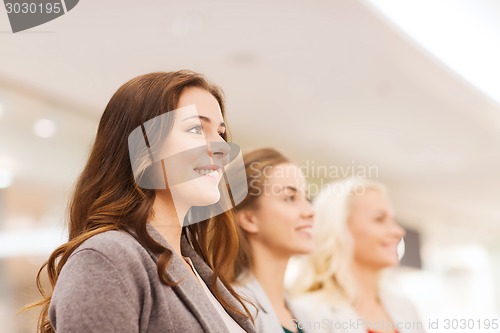 Image of happy young women in mall or business center