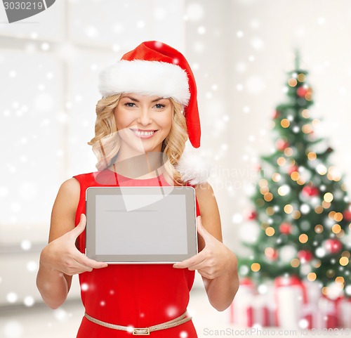 Image of woman in santa helper hat showing tablet pc screen