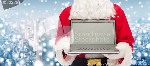 Image of close up of santa claus with laptop