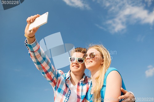 Image of smiling couple having fun outdoors