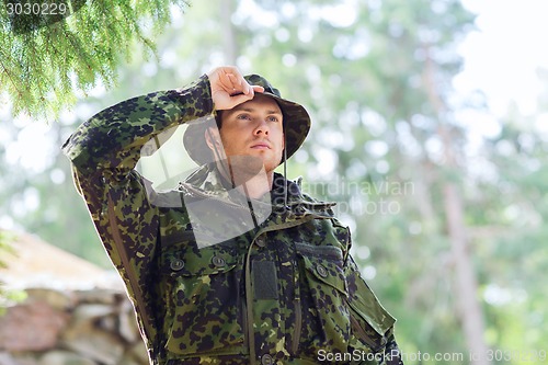 Image of young soldier or ranger in forest