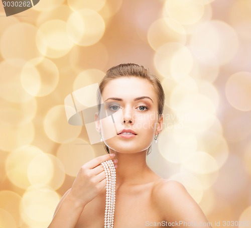 Image of beautiful woman with pearl earrings and bracelet