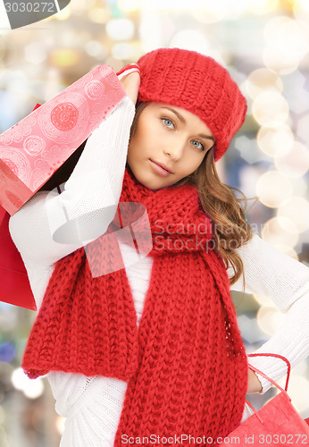 Image of smiling young woman with shopping bags