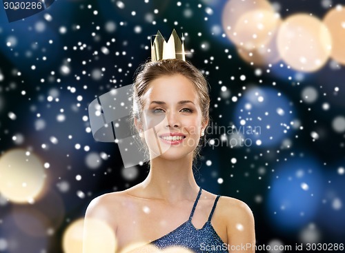 Image of smiling woman in evening dress wearing crown