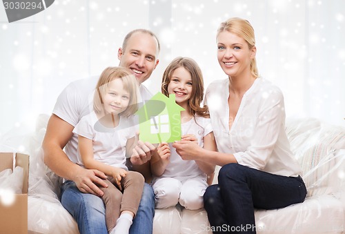 Image of smiling parents and two little girls at new home