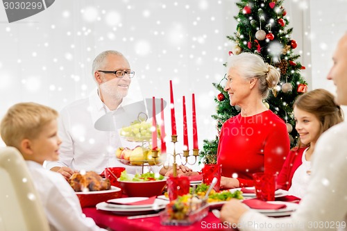 Image of smiling family having holiday dinner at home