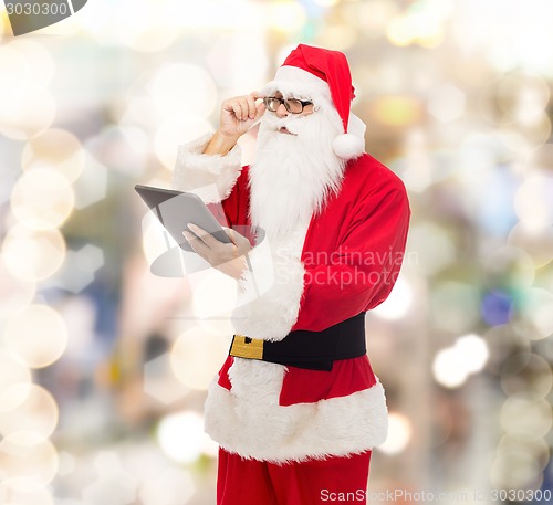 Image of man in costume of santa claus with tablet pc