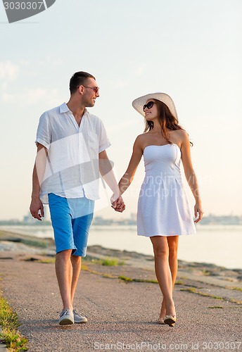 Image of smiling couple walking outdoors