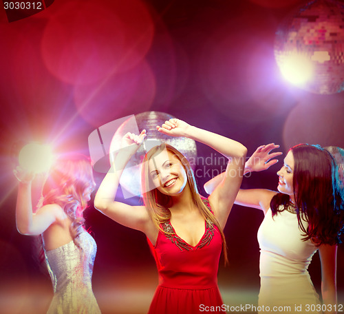 Image of three smiling women dancing in the club