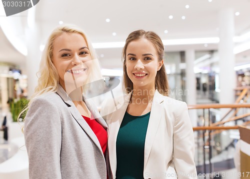 Image of happy young women in mall or business center