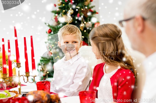 Image of smiling family having holiday dinner at home