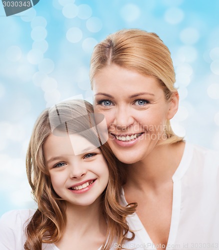 Image of smiling mother and little girl