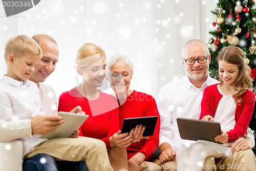 Image of smiling family with tablet pc computers at home
