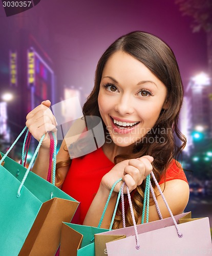 Image of smiling young woman with shopping bags