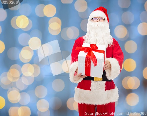 Image of man in costume of santa claus with gift box