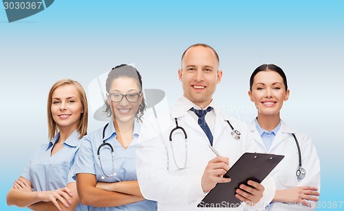 Image of group of smiling doctors with clipboard
