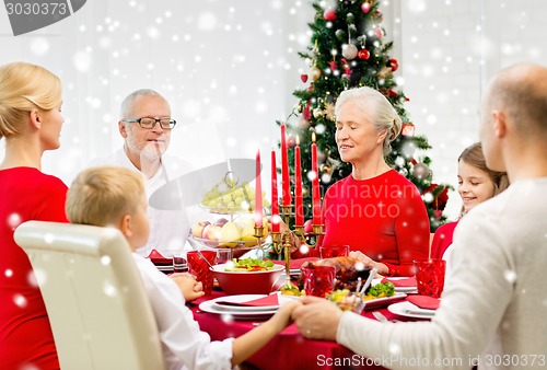 Image of smiling family having holiday dinner at home