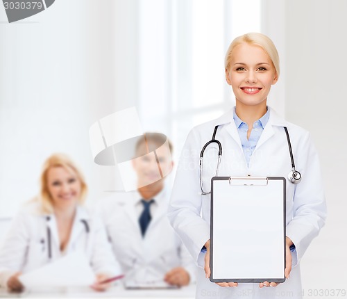 Image of smiling female doctor with clipboard