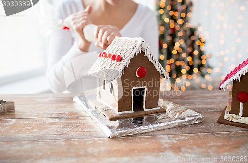 Image of close up of woman making gingerbread houses