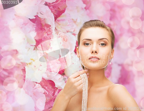 Image of beautiful woman with pearl earrings and bracelet