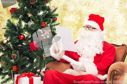 Image of man in costume of santa claus with letter
