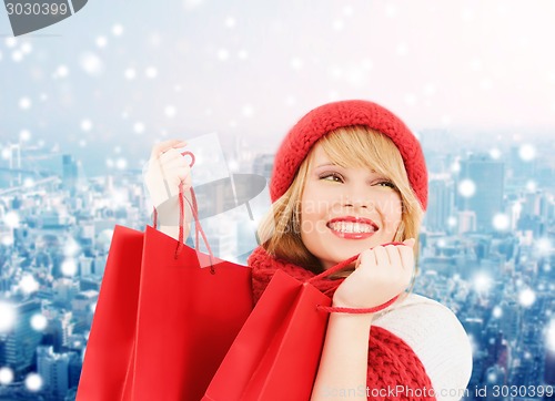 Image of smiling young woman with shopping bags