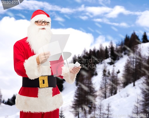 Image of man in costume of santa claus with letter