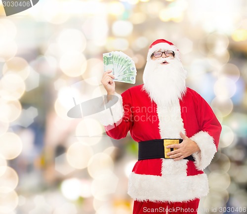 Image of man in costume of santa claus with euro money