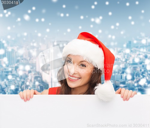 Image of woman in santa helper hat with blank white board