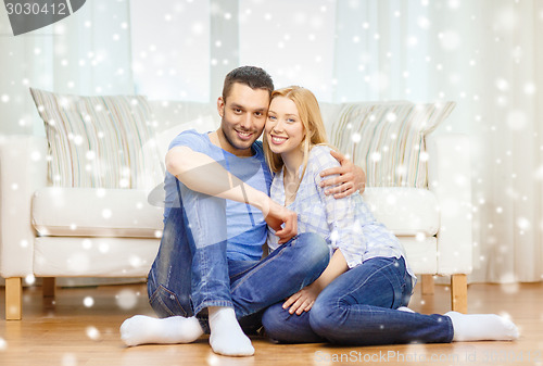 Image of happy couple hugging at home