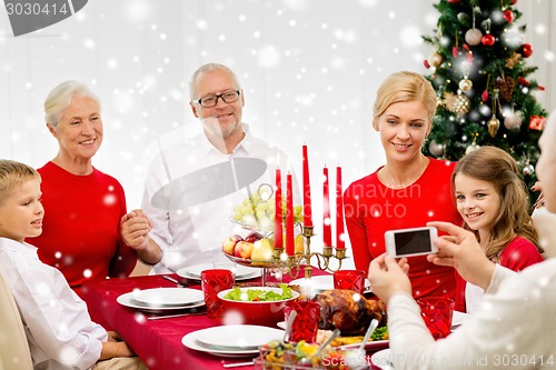 Image of smiling family having holiday dinner at home