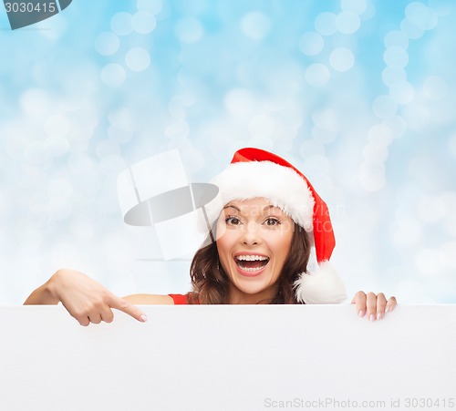 Image of woman in santa helper hat with blank white board