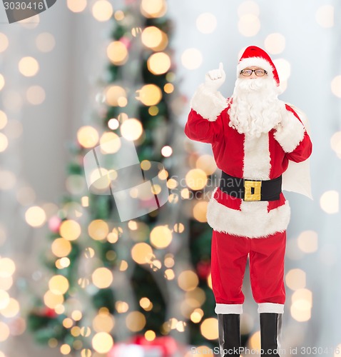 Image of man in costume of santa claus with bag