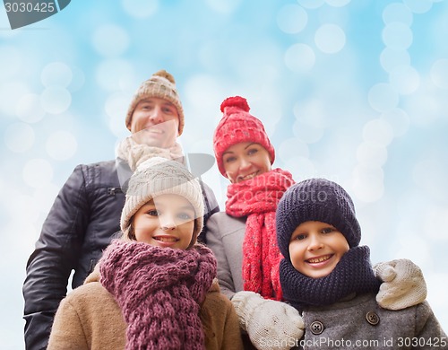 Image of happy family in winter clothes outdoors